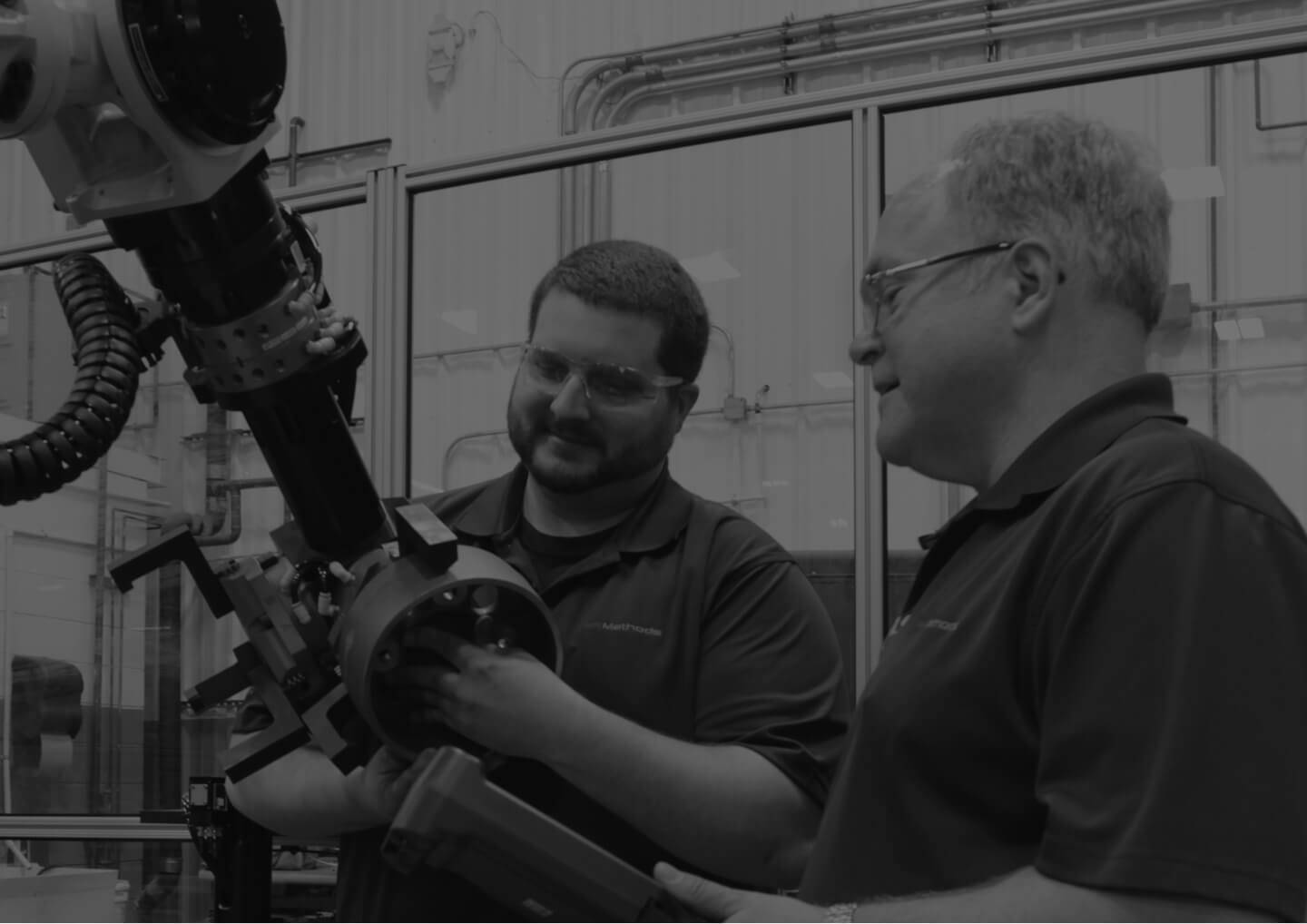 Two employees working on a machine