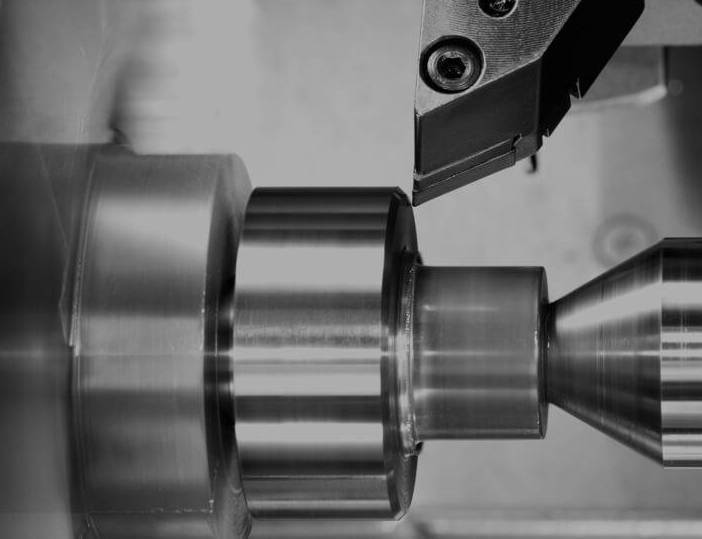 A lathe cutting a piece of metal